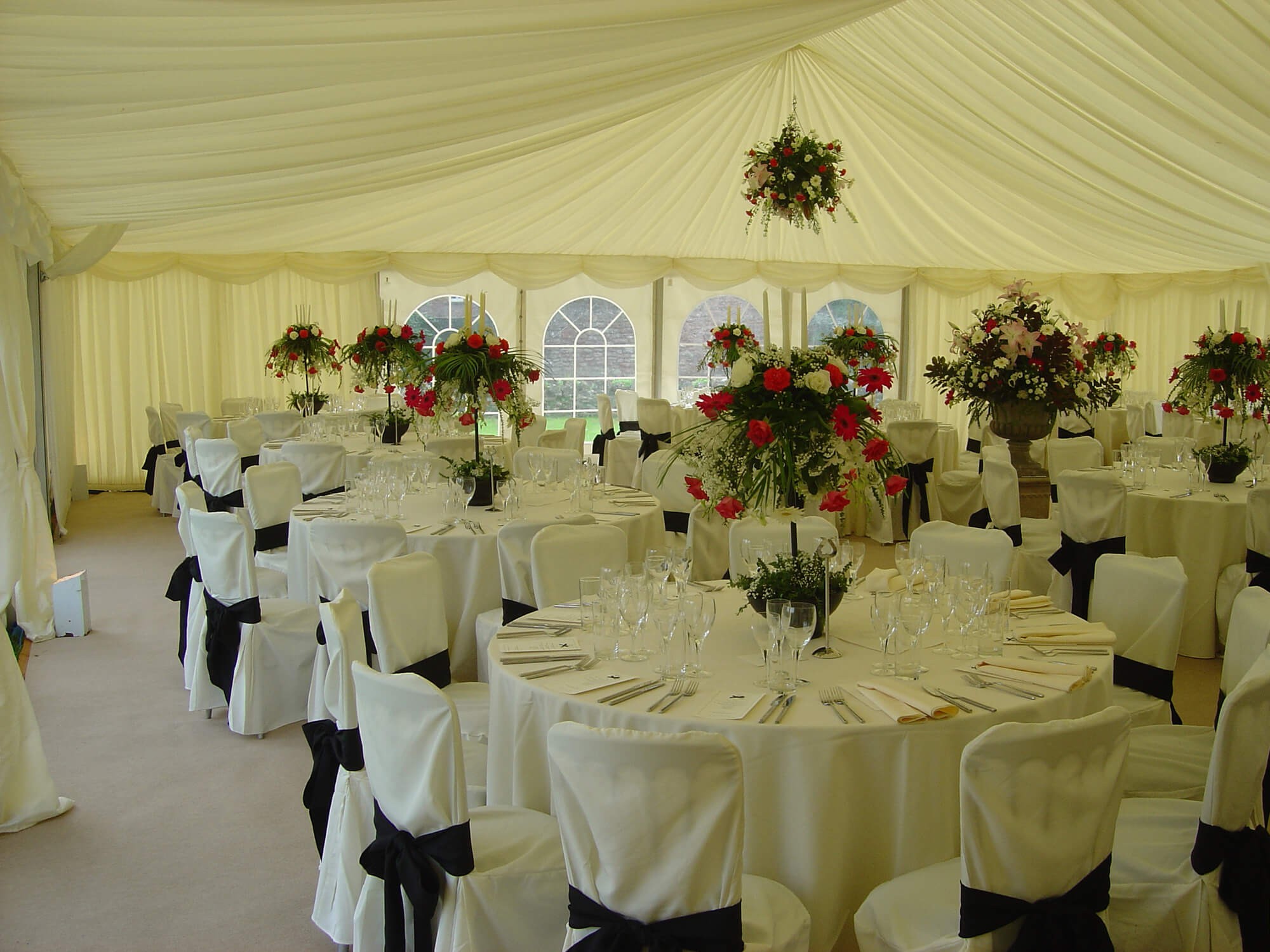 Marquee interior with a hanging floral display suspended from the roof
