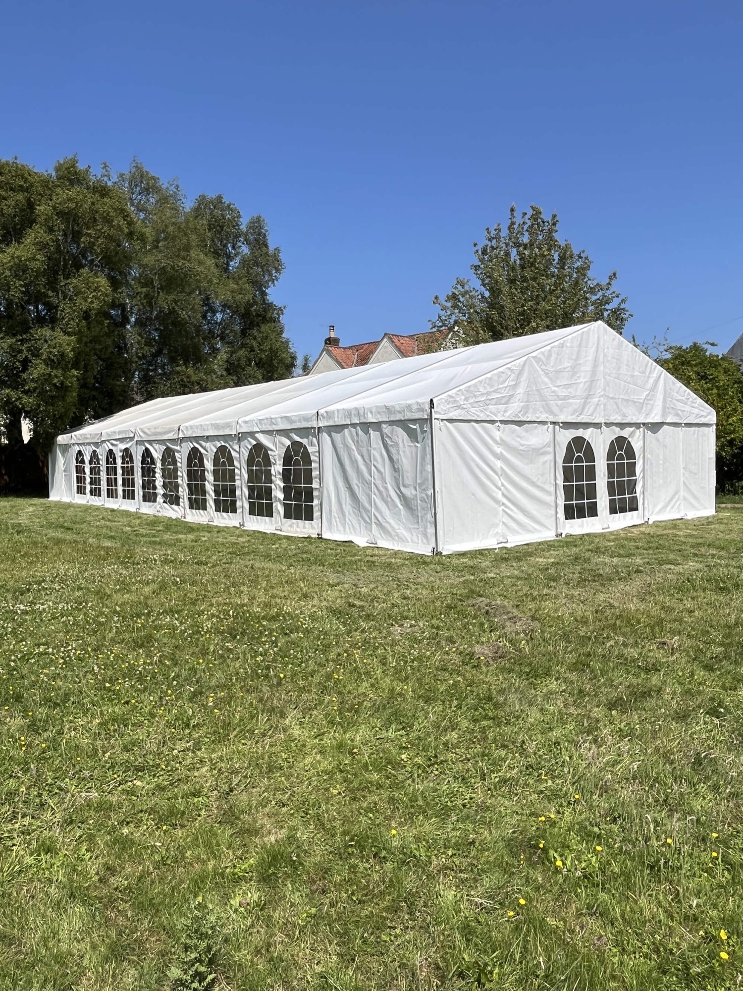 Exterior of a white framed wedding marquee on a Somerset lawn