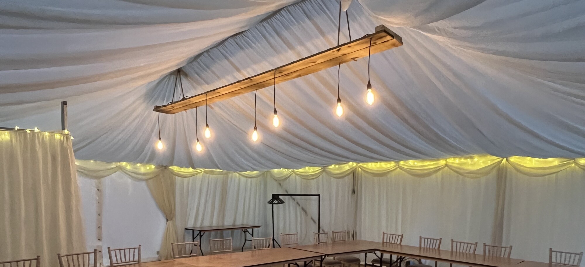 Close-up of rustic wooden plank flooring inside a marquee