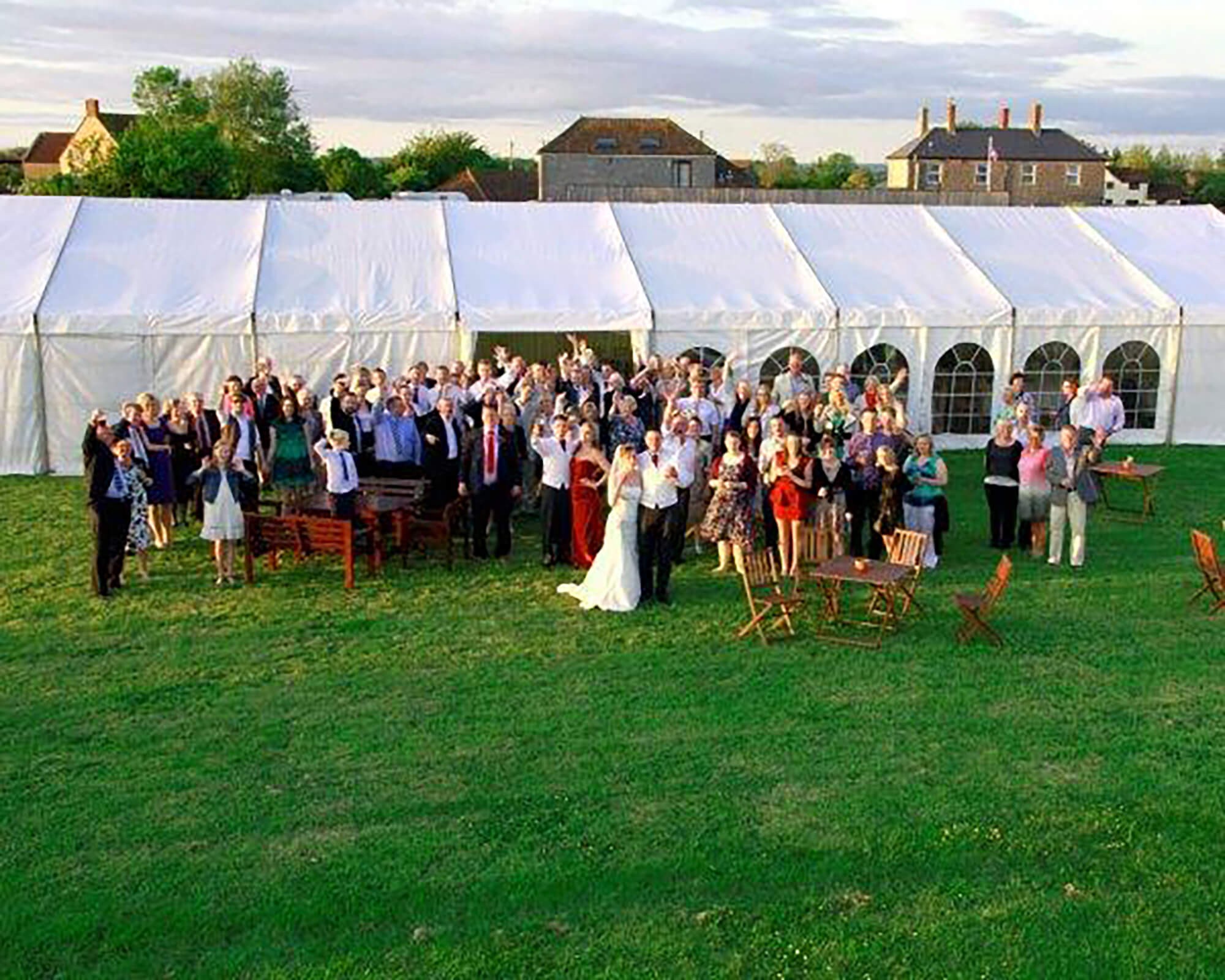 Dressed wedding marquee interior with round tables and soft lighting