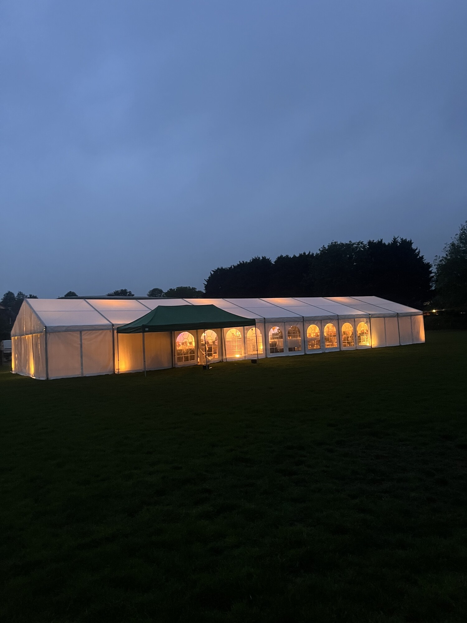 Party marquee glowing at dusk in Wells